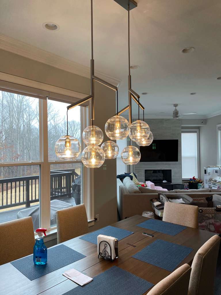 Modern dining room with pendant globe lights and a view of the outdoors.